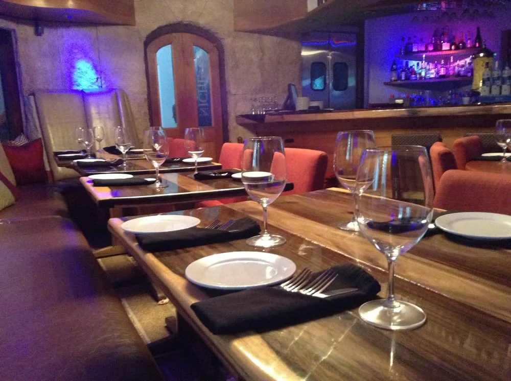 Mahogany live-edge tables and the etched-glass Niche door